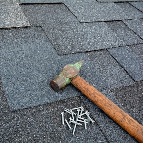 shingle roof with a hammer and nails